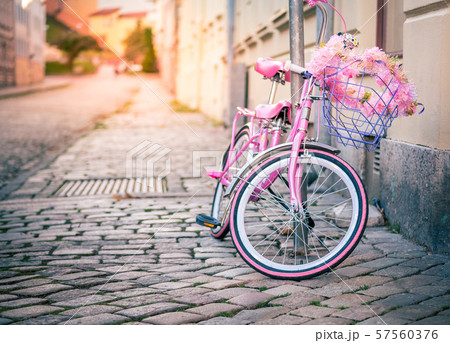 Pink kids bicycle with shopping basket 57560376