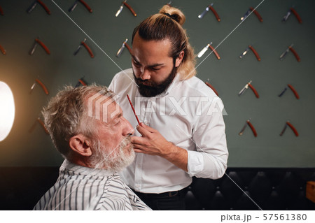 professional talented barber going to make new hairstyle 57561380
