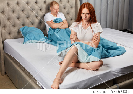 angry unhappy couple isn't talking after argument in bed at home in bedroom 57562889