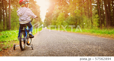 a child on a bicycle in helmet 57562894