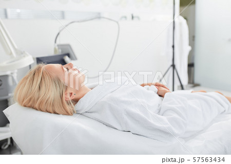 fair haired woman staying calm while lying on a medical chair 57563434