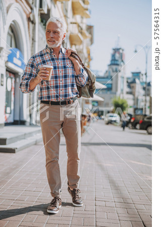 Mature man enjoying coffee in the street stock photo Mature man enjoying coffee in the street stock photo 57564315