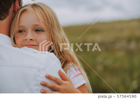 Pretty little daughter is hugging her father 57564590