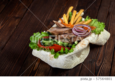 Turkish and Arabic Traditional Ramadan mix kebab plate. Kebab beef on lavash bread with sauce and Turkish and Arabic Traditional Ramadan mix kebab plate. Kebab beef on lavash bread with sauce and 57564801