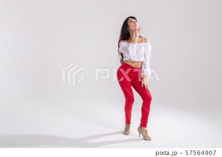 Latin dance, bachata lady, jazz modern and vogue dance concept - Beautiful young woman dancing on Latin dance, bachata lady, jazz modern and vogue dance concept - Beautiful young woman dancing on 57564907