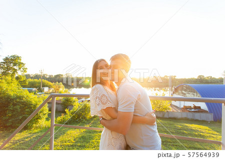 Handsome man and young woman kissing together on nature 57564939