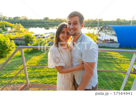 Relationship, funny people and nature concept - Young couple having fun in park. Relationship, funny people and nature concept - Young couple having fun in park. 57564941