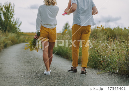 Calm young parents walking on the road outdoors 57565401
