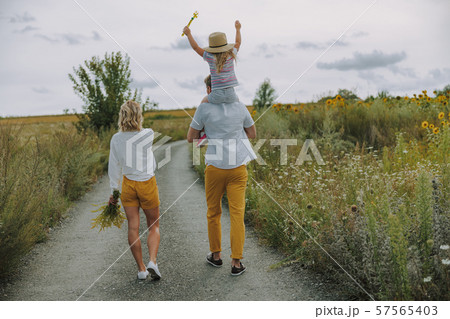 Young parents walking on the road outdoors 57565403
