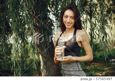Beautiful sports girl in a summer park Beautiful sports girl in a summer park 57565497