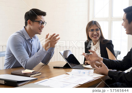 Business people laughing together while discussing 57565644