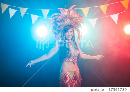 Carnival, dancer and holiday concept - Beauty brunette woman in cabaret suit and headdress with 57565789
