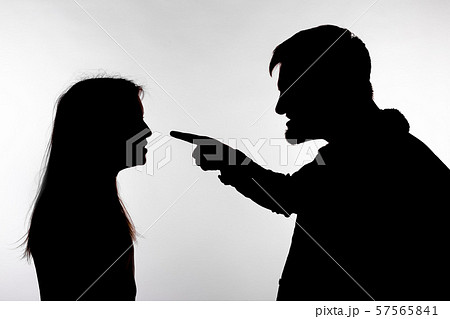 Aggression and abuse concept - man and woman expressing domestic violence in studio silhouette Aggression and abuse concept - man and woman expressing domestic violence in studio silhouette 57565841
