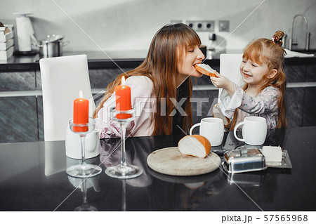 Mother with daughter in a kitchen 57565968