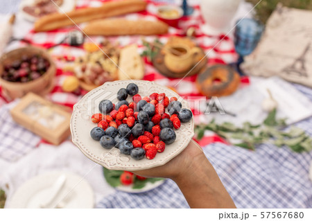 Woman in checkered stylish dress take berry from 57567680