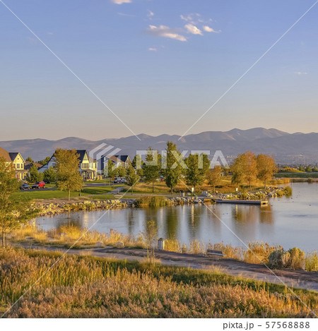 Trail and homes in Oquirrh Lake against mountain 57568888