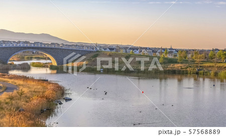 Trail and arched bridge in man made Oquirrh Lake 57568889