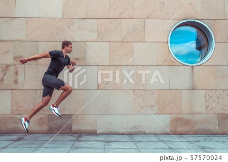 man summer i city, jogging jump. Active lifestyle, fitness workout, motivation in motion, fast and 57570024