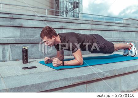 Male athlete, stands in bar, training muscles of back and abs, lifestyle fitness style will rob Male athlete, stands in bar, training muscles of back and abs, lifestyle fitness style will rob 57570110