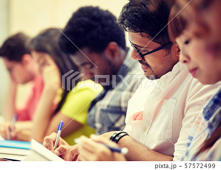 group of international students writing at lecture 57572499
