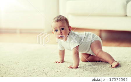 little baby in diaper crawling on floor at home little baby in diaper crawling on floor at home 57572592