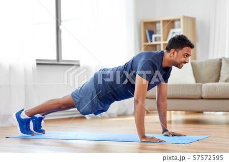 indian man doing push ups at home 57572595