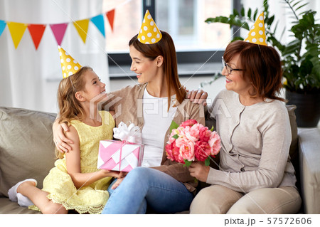 daughter with gift box greeting mother on birthday daughter with gift box greeting mother on birthday 57572606