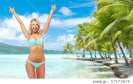 happy young woman in bikini doing fist pump happy young woman in bikini doing fist pump 57572674