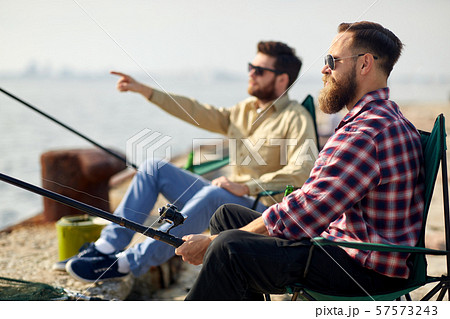 happy friends with fishing rods on pier happy friends with fishing rods on pier 57573243