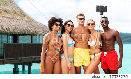 happy friends taking selfie on summer beach 57573276