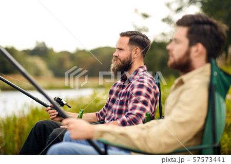 friends with fishing rods at lake or river friends with fishing rods at lake or river 57573441