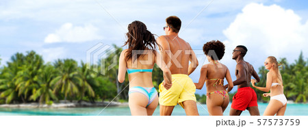 happy friends running on summer beach 57573759