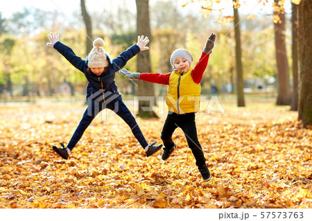 happy children running at autumn park happy children running at autumn park 57573763
