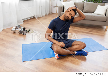 man training and stretching body at home 57574146