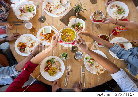 international friends eating at restaurant international friends eating at restaurant 57574317