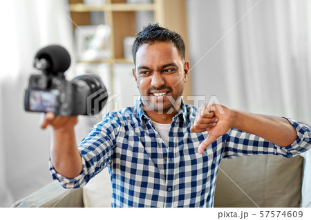 male video blogger with camera blogging at home male video blogger with camera blogging at home 57574609