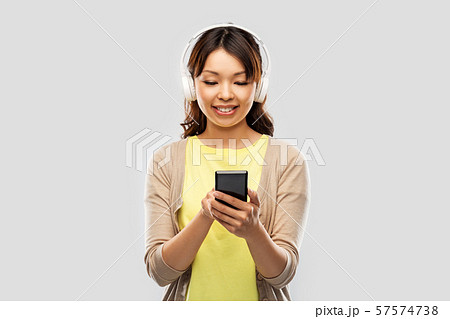 asian woman in headphones listening to music asian woman in headphones listening to music 57574738