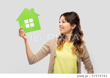 happy asian woman with green house happy asian woman with green house 57574741