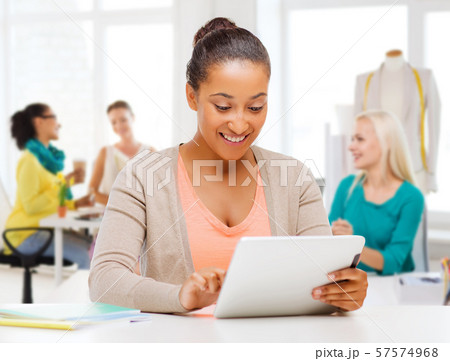 fashion designer with tablet computer over studio 57574968