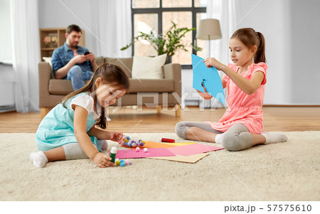 happy sisters doing arts and crafts at home happy sisters doing arts and crafts at home 57575610