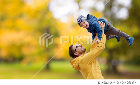 father with son playing and having fun in autumn 57575937