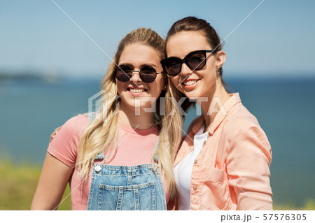 teenage girls or best friends at seaside in summer teenage girls or best friends at seaside in summer 57576305