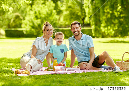 portrait of family having picnic at summer park 57576526