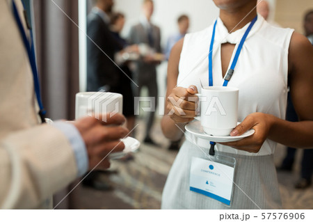 business people with conference badges and coffee 57576906