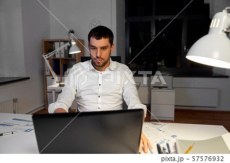 businessman with laptop working at night office businessman with laptop working at night office 57576932