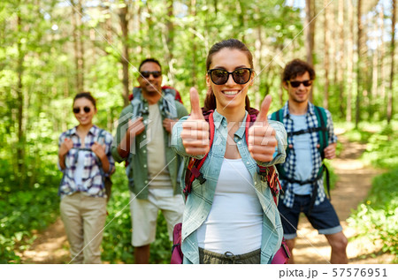 friends with backpacks showing thumbs up in forest friends with backpacks showing thumbs up in forest 57576951