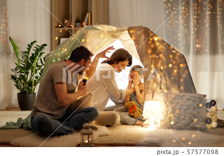 father telling scary stories to his daughter father telling scary stories to his daughter 57577098