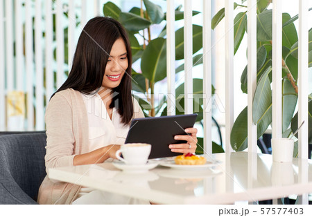 asian woman with tablet pc at cafe or coffee shop asian woman with tablet pc at cafe or coffee shop 57577403