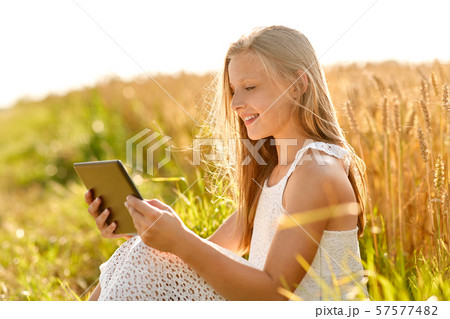 smiling with tablet computer on cereal field smiling with tablet computer on cereal field 57577482
