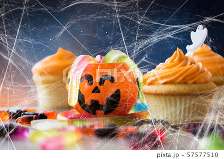 halloween party cupcakes and candies on table 57577510